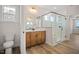 Modern bathroom with a walk-in shower, double vanity, and wood-look floors at 1221 Cricket St, Elon, NC 27244