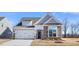 Two-story house with stone accents and a two-car garage at 1221 Cricket St, Elon, NC 27244