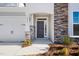 Inviting front entrance with stone detailing and a charming porch at 1221 Cricket St, Elon, NC 27244