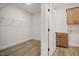 Laundry room with upper cabinets, built-in shelving, and a large closet at 1221 Cricket St, Elon, NC 27244