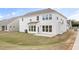 Newly sodded backyard with a concrete patio and white siding on the home's exterior at 1233 Cricket St, Elon, NC 27244