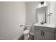 A clean half bath features a modern vanity with storage at 1233 Cricket St, Elon, NC 27244