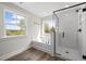 Bathroom with a tub, shower, and many windows providing natural light at 1233 Cricket St, Elon, NC 27244