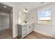 Bathroom vanity with gray cabinetry, quartz countertop, and natural light at 1233 Cricket St, Elon, NC 27244