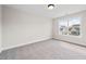 Cozy carpeted bedroom with natural light from the large window at 1233 Cricket St, Elon, NC 27244