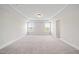 Spacious bedroom featuring neutral carpeting, two windows and a trey ceiling at 1233 Cricket St, Elon, NC 27244