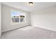 Bright bedroom with plush carpeting, a large window, and natural light at 1233 Cricket St, Elon, NC 27244