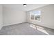 Bright bedroom with plush carpeting and a large window overlooking the neighborhood at 1233 Cricket St, Elon, NC 27244