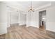 Bright dining room with elegant chandelier and hardwood floors at 1233 Cricket St, Elon, NC 27244