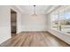 Bright dining room with hardwood floors, large windows, and elegant trim at 1233 Cricket St, Elon, NC 27244
