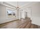 Elegant dining area with hardwood flooring, large windows and recessed lighting at 1233 Cricket St, Elon, NC 27244
