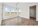 Light-filled dining room with multiple windows and a modern chandelier at 1233 Cricket St, Elon, NC 27244