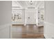 Inviting foyer with hardwood floors, a tray ceiling, and a view of the front door at 1233 Cricket St, Elon, NC 27244