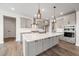 Bright, modern kitchen with a large island and stainless steel range hood at 1233 Cricket St, Elon, NC 27244