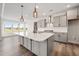 Modern kitchen featuring an island, gray cabinets, and stainless steel appliances at 1233 Cricket St, Elon, NC 27244