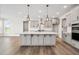 Modern kitchen features an island, gray cabinets, and stainless steel appliances at 1233 Cricket St, Elon, NC 27244