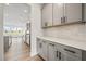 View of a contemporary kitchen with gray cabinets and tile backsplash at 1233 Cricket St, Elon, NC 27244