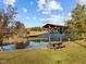 Picnic table under a covered pavilion by the lake at 138 Ottawa Dr, Louisburg, NC 27549