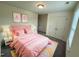 Bright bedroom with a pink bed, colorful rug, and plentiful lighting at 34 Mcintosh Ct, Fuquay Varina, NC 27526