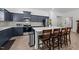 Modern kitchen with navy cabinetry, stainless steel appliances, a quartz island, and stylish backsplash at 34 Mcintosh Ct, Fuquay Varina, NC 27526