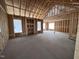 Spacious living room featuring exposed beams and natural light from the strategically placed windows at 612 Tuscany Cir, Princeton, NC 27569