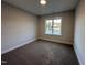 Bright bedroom with carpet flooring and a large window offering natural light at 613 Tuscany Cir, Princeton, NC 27569