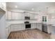 Stylish kitchen featuring gray cabinetry, granite countertops, and stainless steel appliances at 613 Tuscany Cir, Princeton, NC 27569