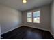 Empty room with hardwood floors, a window, and gray walls at 700 Tuscany Cir, Princeton, NC 27569