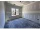 A bedroom featuring a large window that provides natural light, and an unfinished neutral palette at 702 Tuscany Cir, Princeton, NC 27569