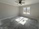 Well-lit bedroom with neutral walls, crown molding, and a large window at 702 Tuscany Cir, Princeton, NC 27569