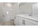 Well-lit bathroom features white cabinetry, a quartz countertop, a single sink, and a shower/tub combo at 77 Windchime Ct, Fuquay Varina, NC 27526