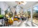 Bright sunroom with vaulted ceilings, skylights, large windows, and tile flooring, offering serene views at 104 Full Moon Ct, Garner, NC 27529