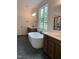 Primary bathroom featuring a standalone tub, double sinks, and a glass-enclosed shower at 1062 Cabin Crk, Pittsboro, NC 27312