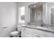 Modern bathroom with granite countertops, white cabinets, and a glass-enclosed shower at 11320 International Dr, Middlesex, NC 27557