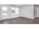 Bright, empty room with modern gray floors, white trim and a door to the outside at 11320 International Dr, Middlesex, NC 27557