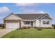 Charming single-story home featuring a stone-accented garage and covered front porch at 11320 International Dr, Middlesex, NC 27557