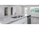 Granite countertop kitchen island with stainless steel sink and dishwasher at 11320 International Dr, Middlesex, NC 27557