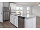 Close-up view of a kitchen island featuring granite countertops and stainless steel dishwasher at 11320 International Dr, Middlesex, NC 27557
