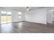 Living room with hardwood floors, sliding door leading to deck, and lots of natural light at 11320 International Dr, Middlesex, NC 27557