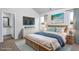 Tastefully decorated main bedroom featuring a beach theme, a TV, and an attached bathroom at 11320 International Dr, Middlesex, NC 27557