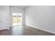 Bright bedroom with sliding glass doors to the deck and wood-look flooring at 11340 International Dr, Middlesex, NC 27557