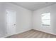 Neutral bedroom with a window and white door at 11340 International Dr, Middlesex, NC 27557