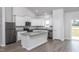 Modern kitchen with white cabinets, granite countertops, stainless steel appliances, and a functional island at 11340 International Dr, Middlesex, NC 27557
