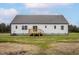 The back of the house features a wooden deck and white siding at 11340 International Dr, Middlesex, NC 27557