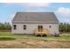 Backyard view of a single Gathering home featuring a small wooden deck at 11360 International Dr, Middlesex, NC 27557