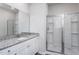 Bright bathroom with a granite countertop, a large mirror, and a glass-enclosed shower at 11360 International Dr, Middlesex, NC 27557