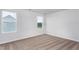 Bright bedroom featuring neutral carpet, two windows, and white walls at 11360 International Dr, Middlesex, NC 27557