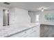 Bright, neutral kitchen with white cabinets, granite countertops, and stainless steel appliances at 11360 International Dr, Middlesex, NC 27557