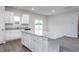 Open kitchen featuring a large center island, white cabinets, and granite countertops at 11360 International Dr, Middlesex, NC 27557