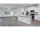 Open layout combines kitchen with stainless steel appliances and a center island at 11360 International Dr, Middlesex, NC 27557